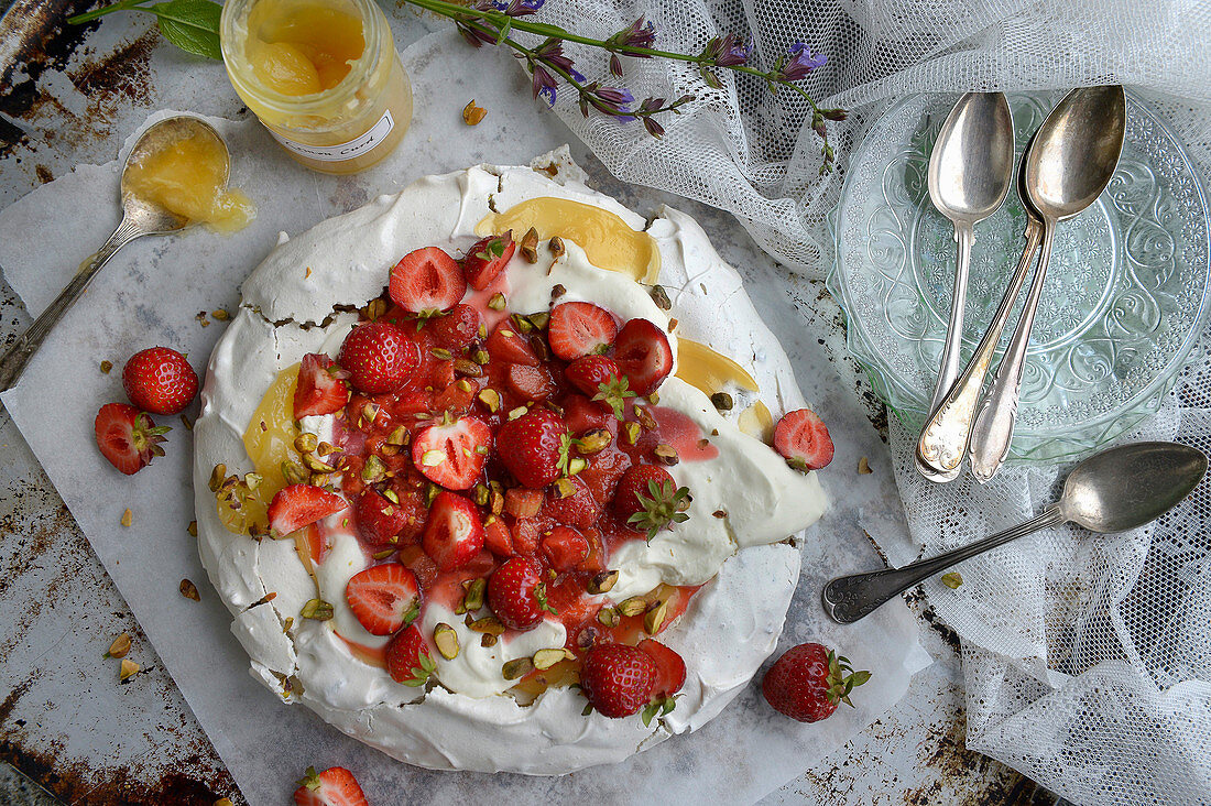 Pavlova with rhubarb, strawberries and pistachios