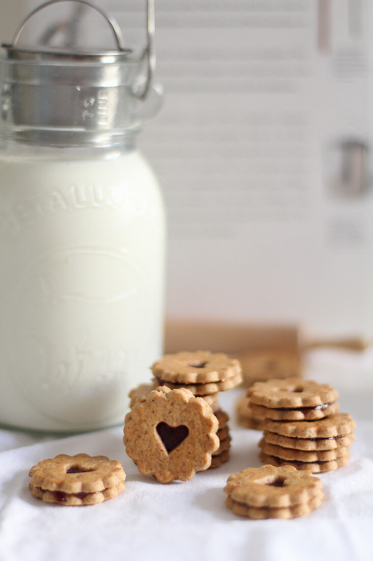 Jam heart cookies beside a milk jug