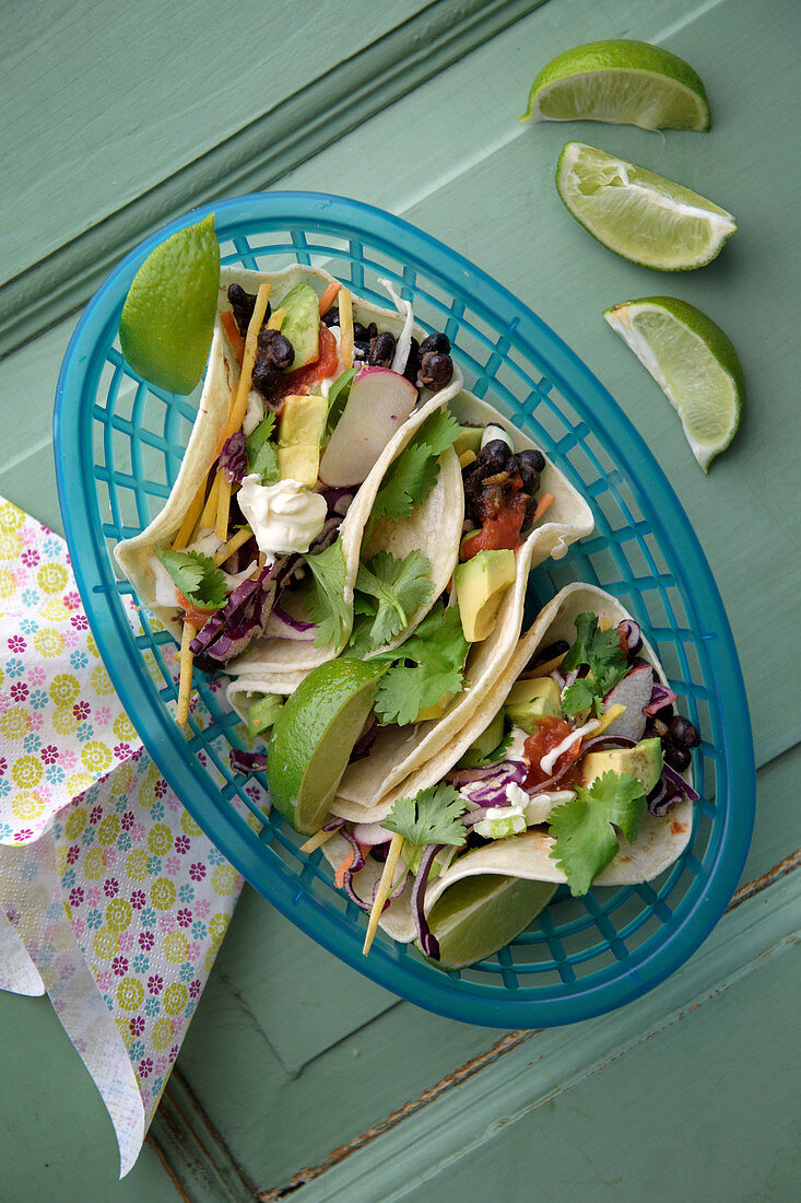 Vegetarian tacos filled with black beans and avocado