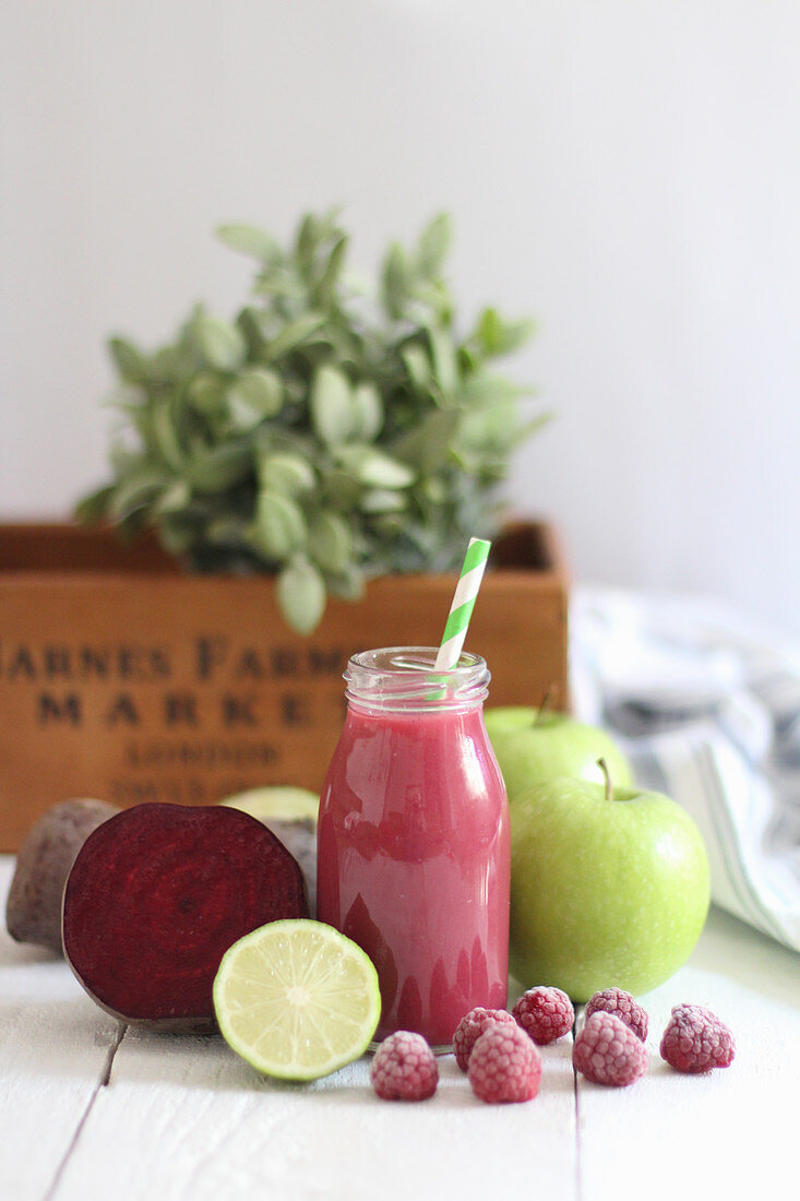 A red smoothie with beetroot, raspberries, lime and apple