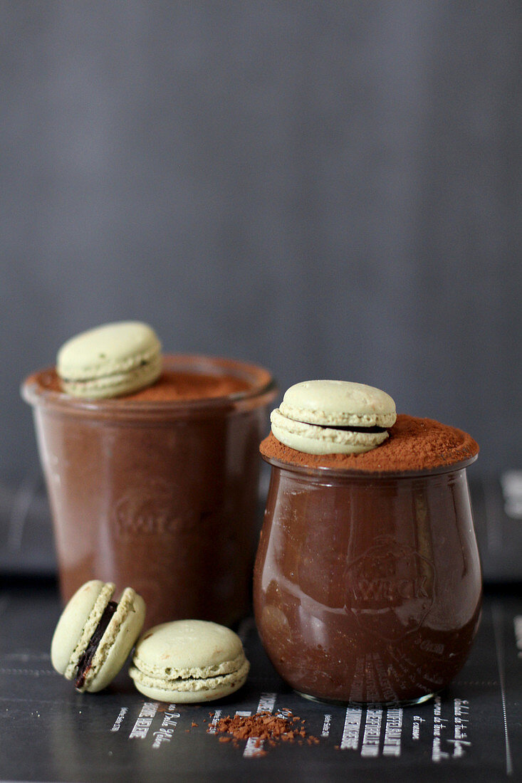 Chocolate mousse served in glasses with macarons