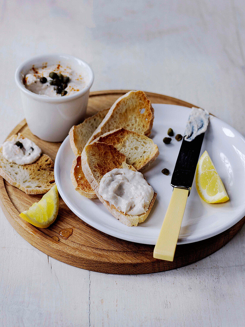 Smoked Mackerel pate with riccota on toast garnished with capers served with lemon wedges gar