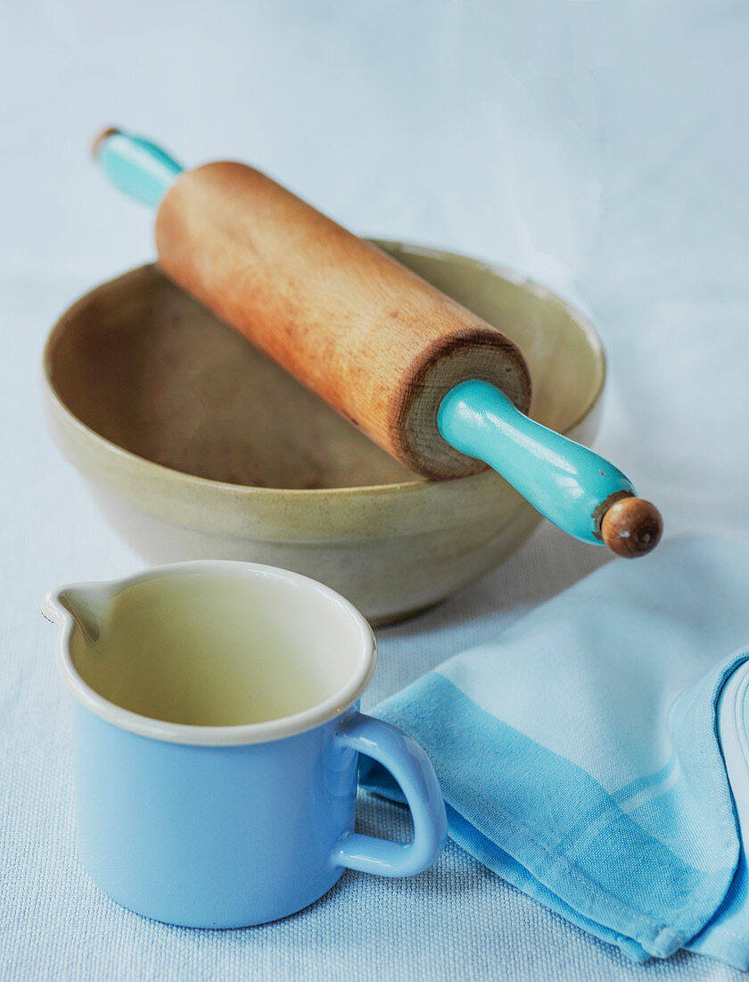 Bowl with rolling pin and measuring jug for pastry