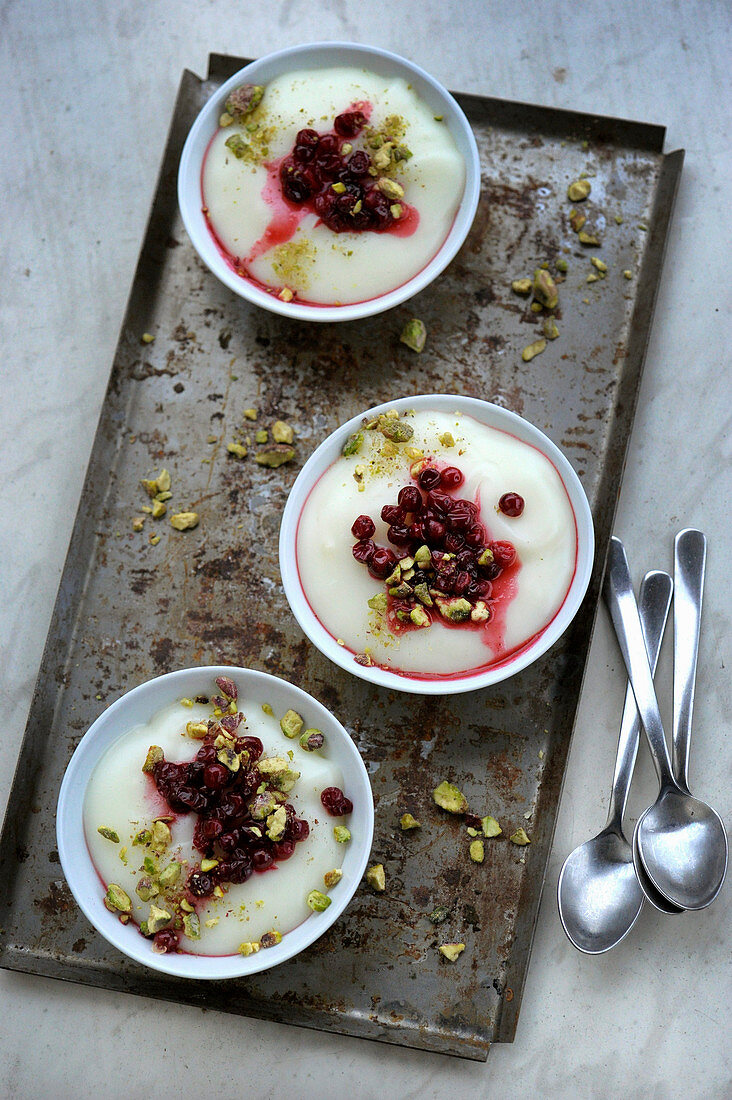 Ashta (Arabian pudding) with lingo berries and pistachio nuts