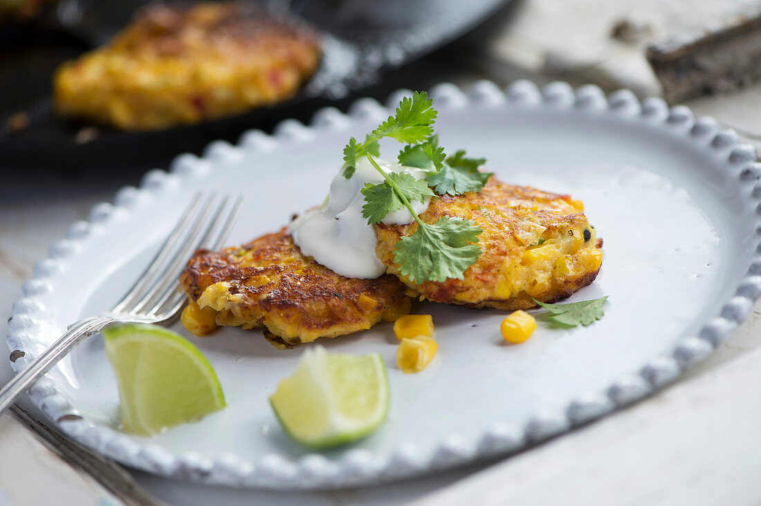 Sweetcorn and chilli fritters with Parmesan cheese and a dollop of sour cream