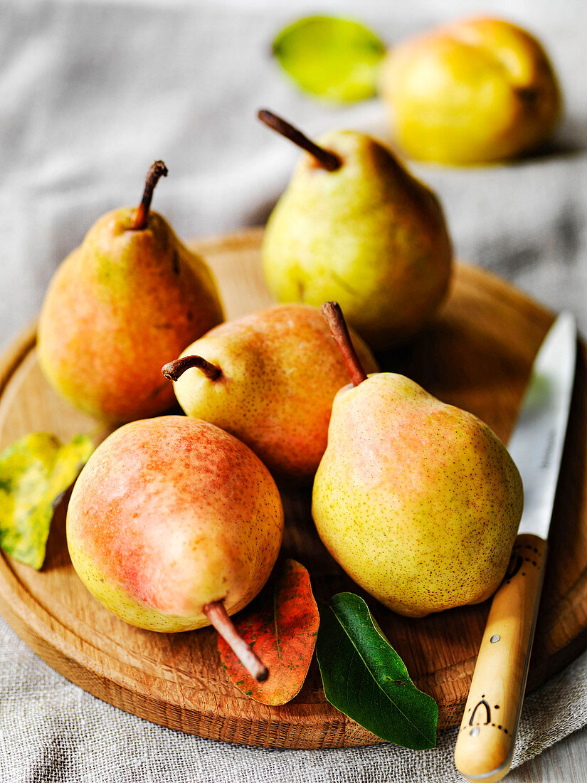 Autumn Comice pears on board with fruit knife