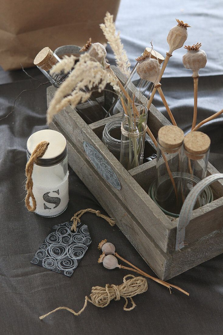 Dried flowers and test tubes in bottle carrier