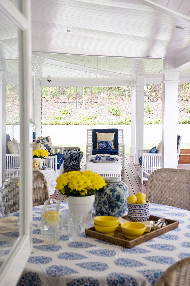 View in through window into veranda decorated in yellow and blue