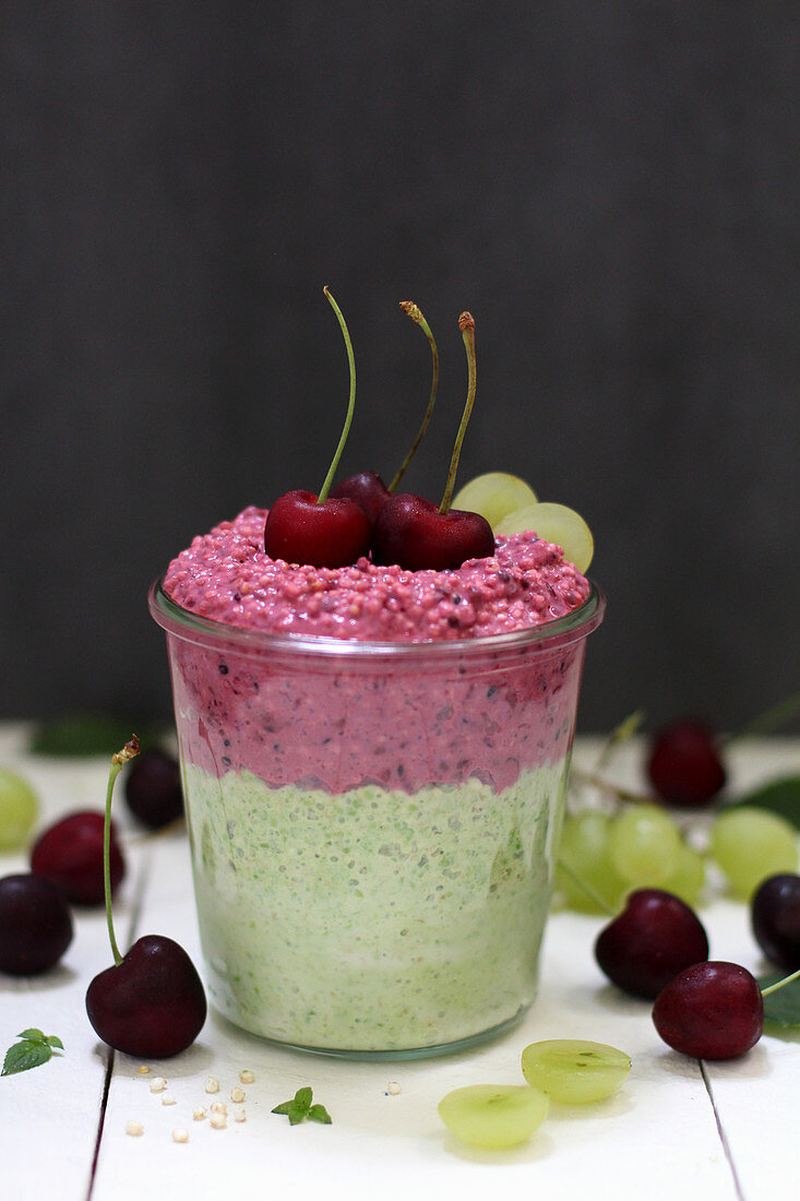 Vegan dessert with cherries and grapes in a glass