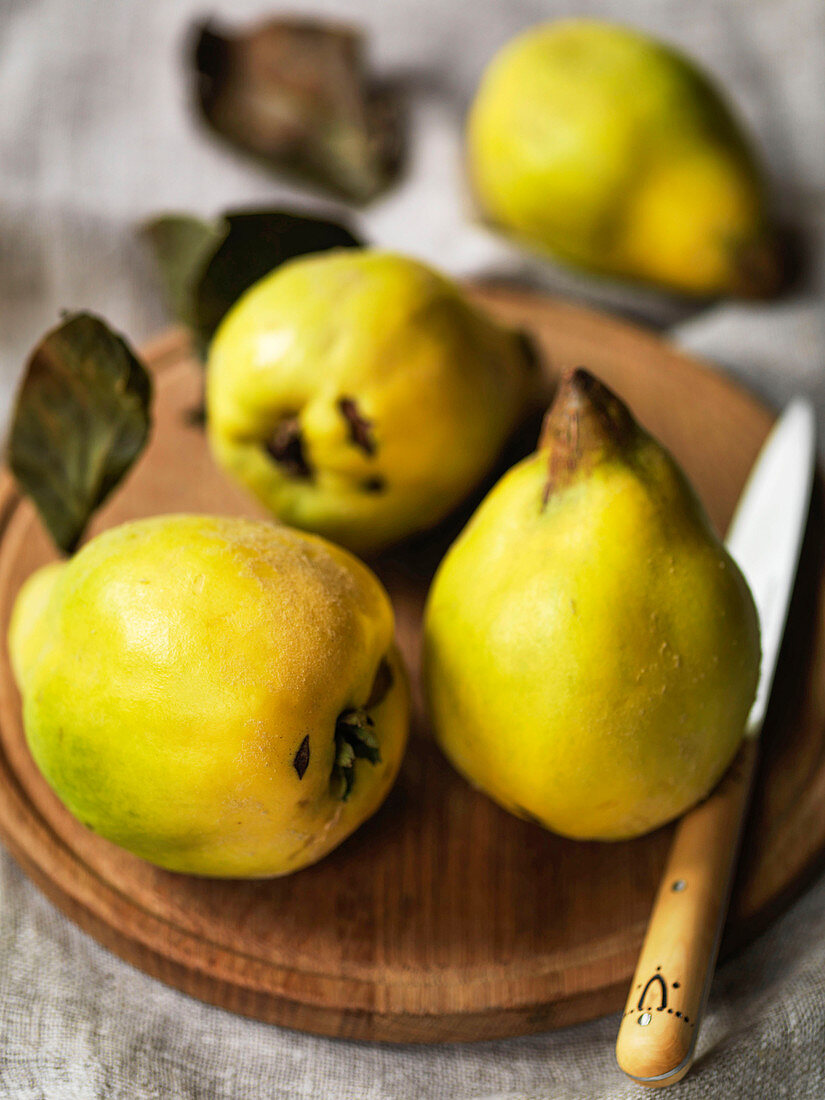 English Quinces on a board with knife