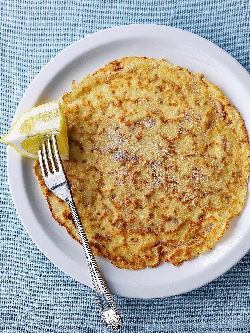 Crepe suzette with lemon and sugar with lemon wedge