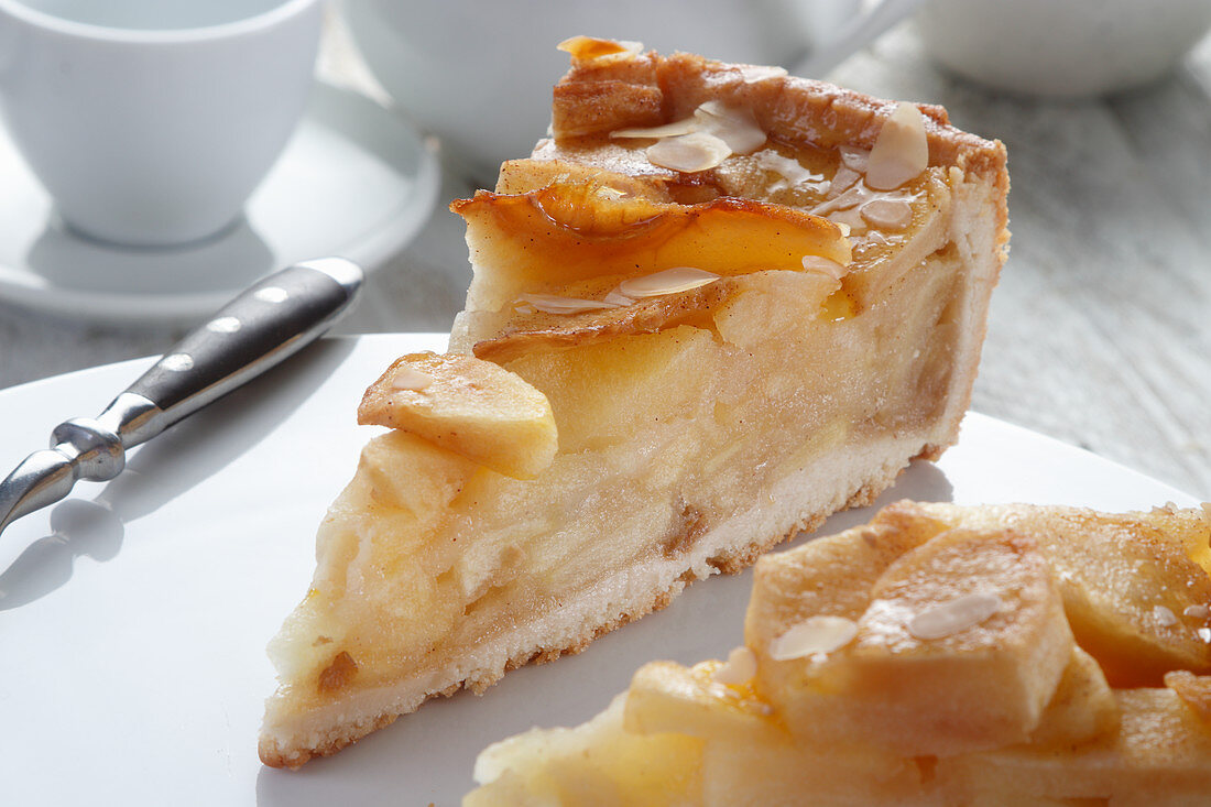 A piece of tart with apples and almond flakes