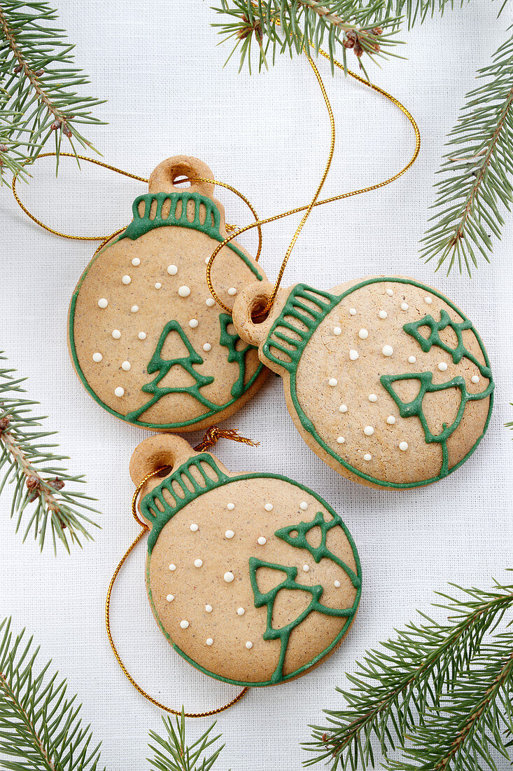 Christmas gingerbread in the shape of Christmas tree bauble with strings