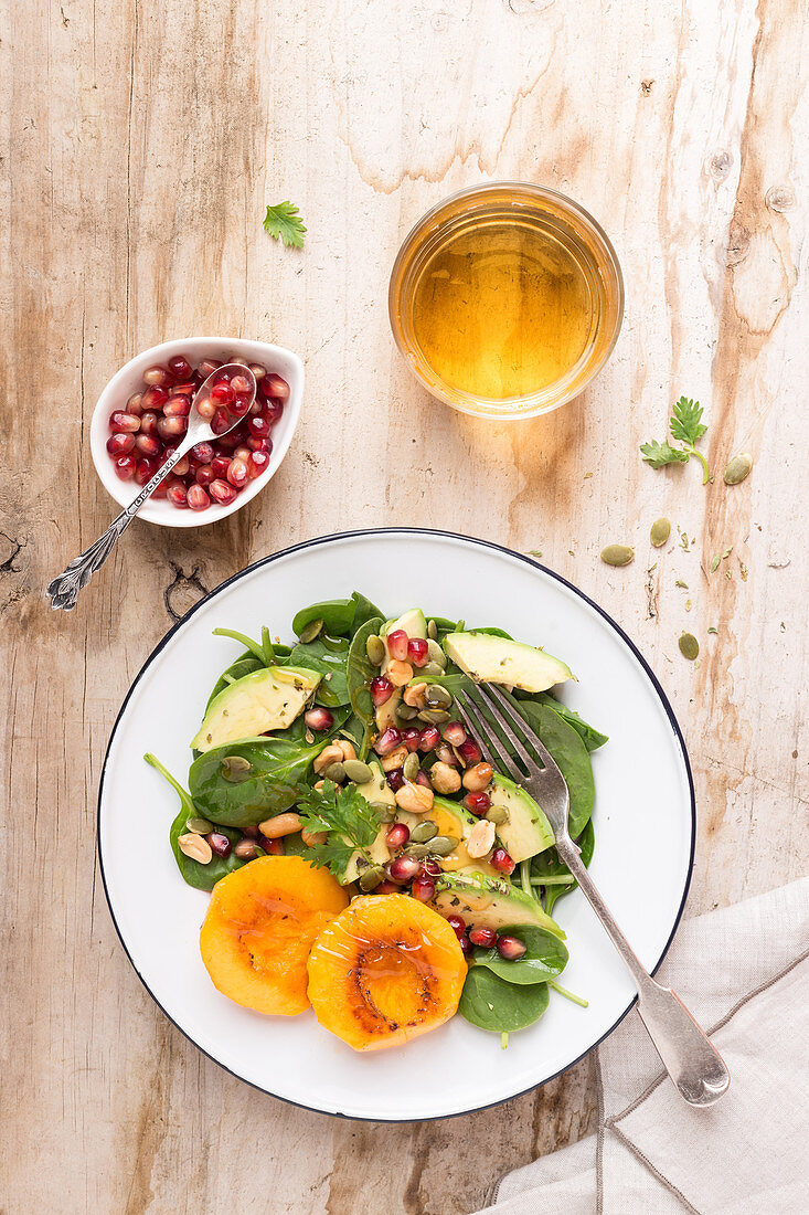 Spinach, pomegranate and peach salad