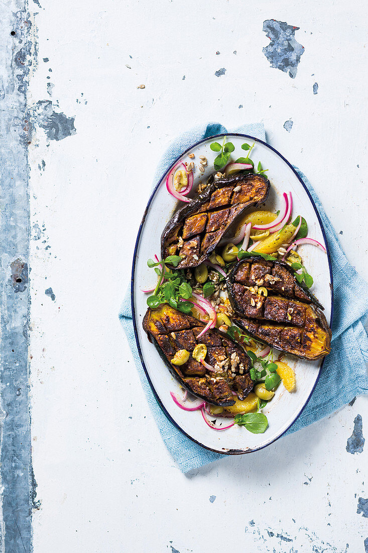 Whole roasted brinjals with oranges and olives