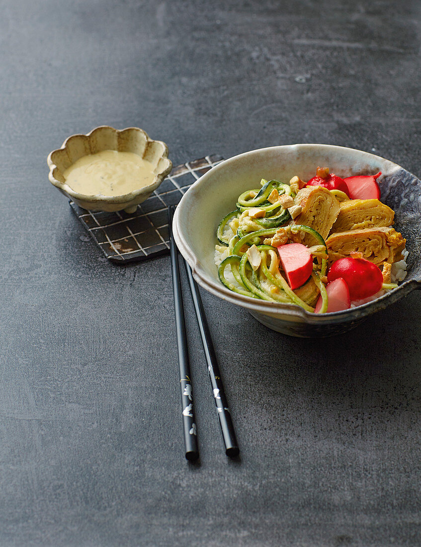 A tamago bowl with tahini and courgette noodles and marinated radishes