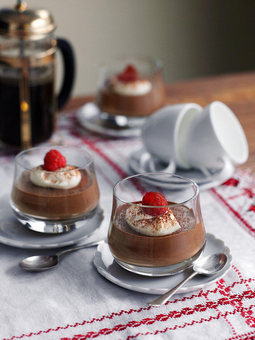Chocolate pudding with cream and raspberries