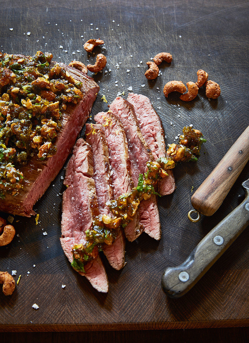 Grilled flank steak with a green fig and cashew crust