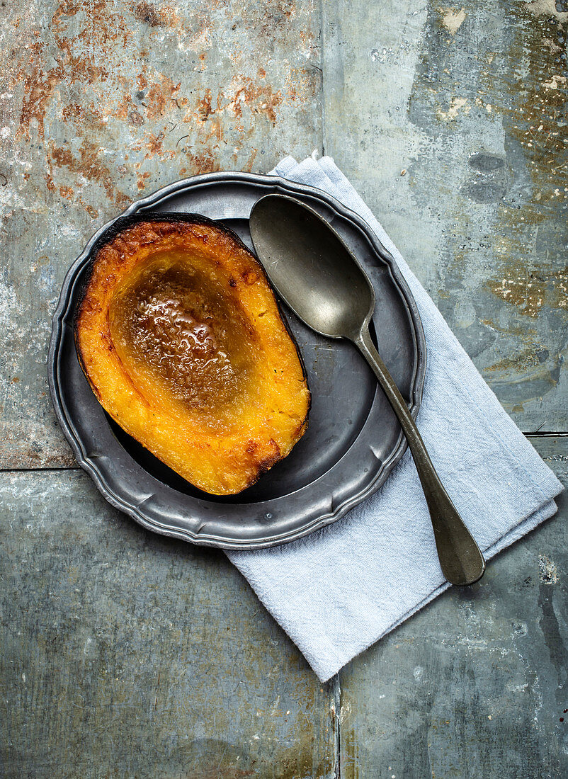 Half a baked acorn squash with brown sugar and butter