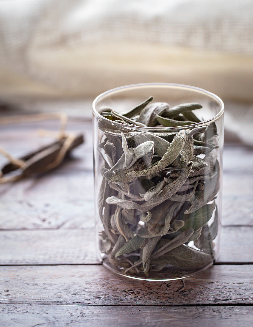 Glass of dried sage leaves