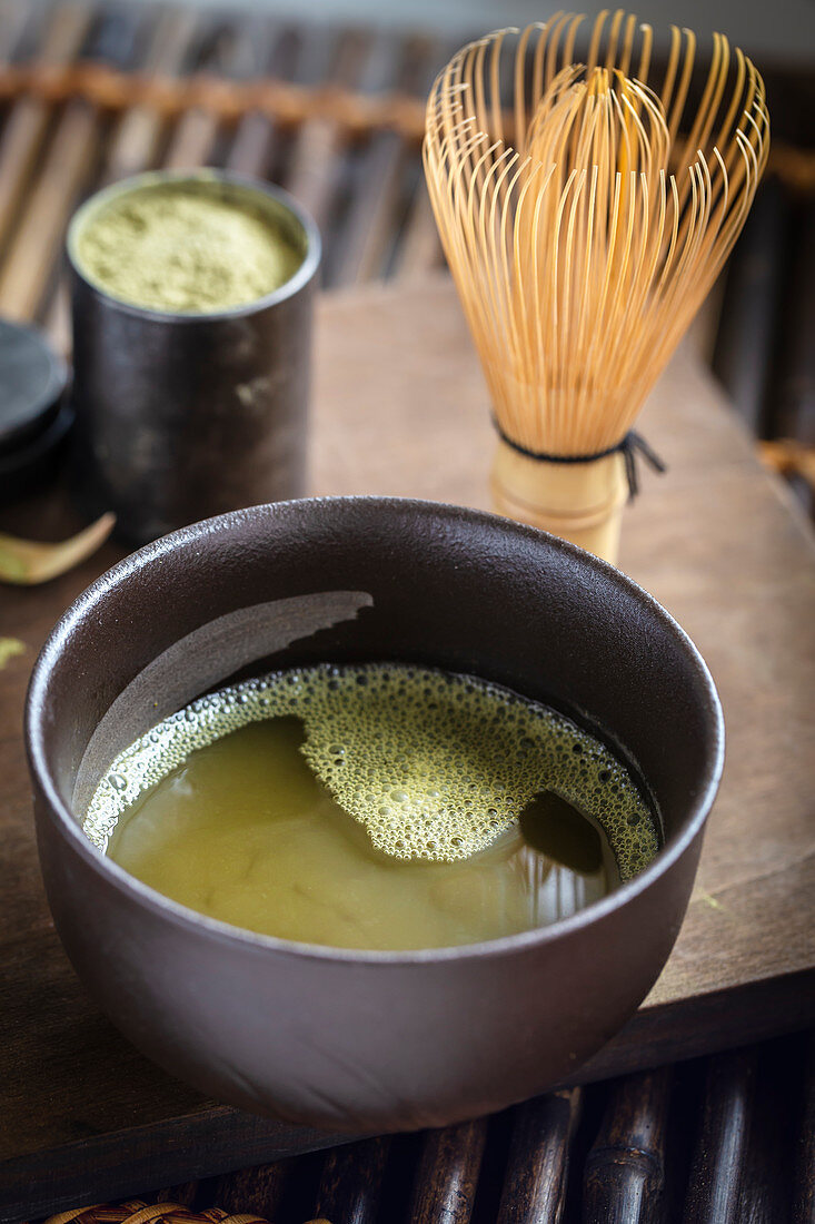 Green matcha tea with whisk