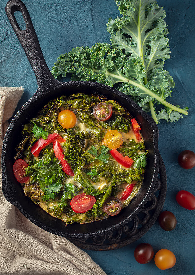 Scrambled eggs with kale and tomatoes