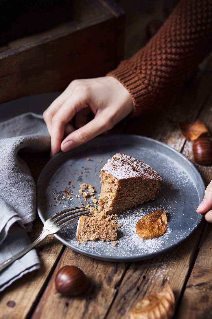 A slice of chestnut cake on rustic table