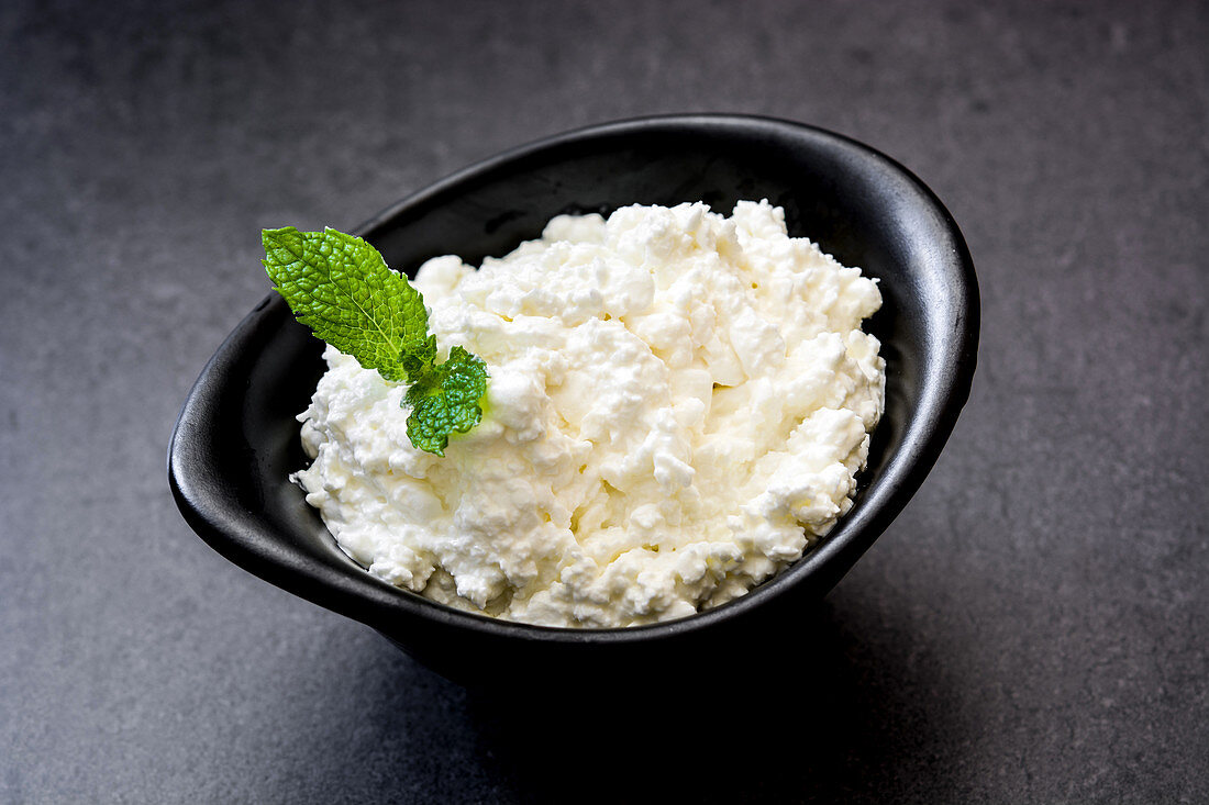 Fresh cottage cheese in a metal bowl