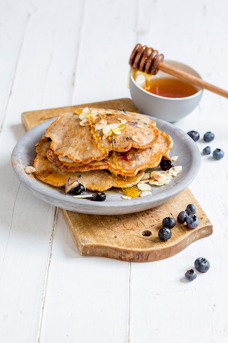 Blueberry and almond pancakes with honey