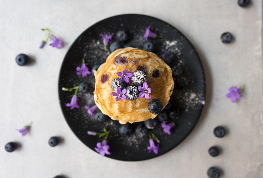 Stack of appetizing tasty crumpets with blueberries