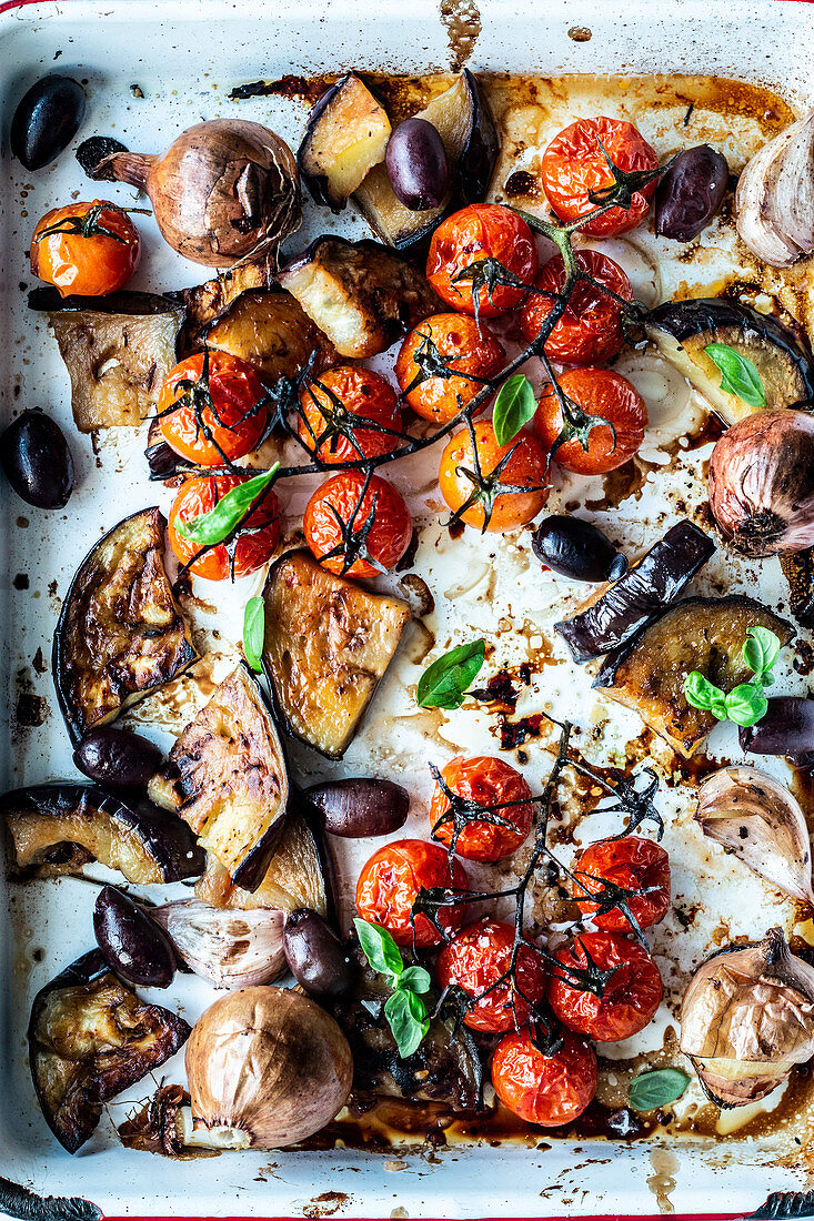 Oven-roasted vegetables with aubergines, tomatoes and onions (seen from above)