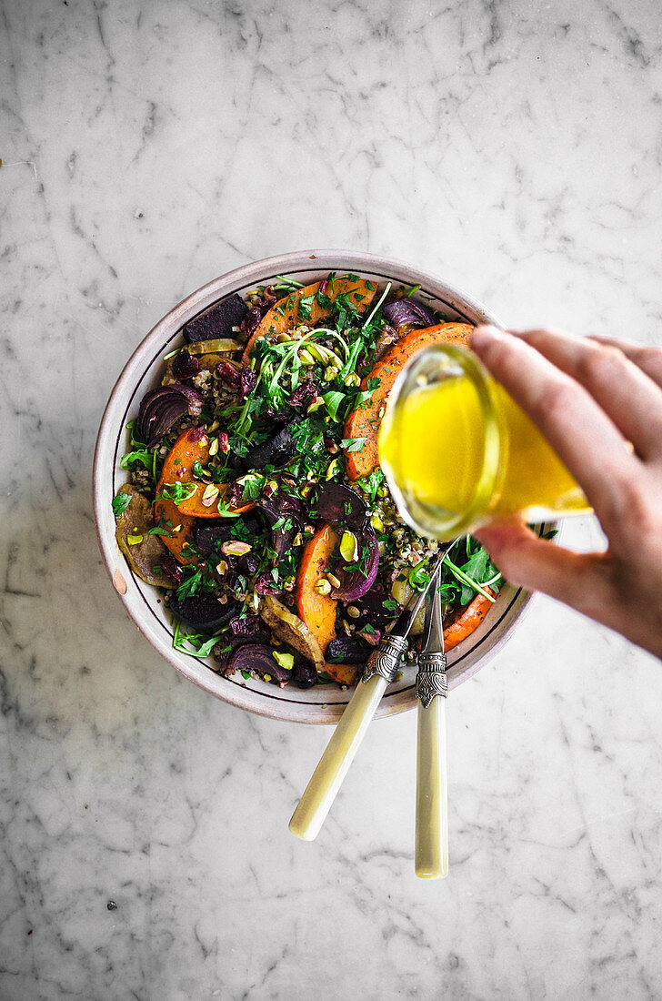 Quinoa lentil salad with rucola, roasted beets, pumpkin, apple, and red onion