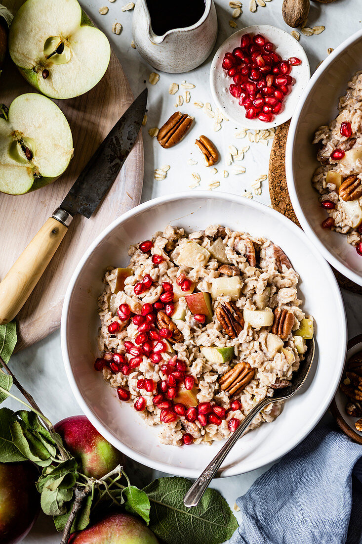 Oatmeal with apple, cinnamon, pecans, and pomegranate for breakfast