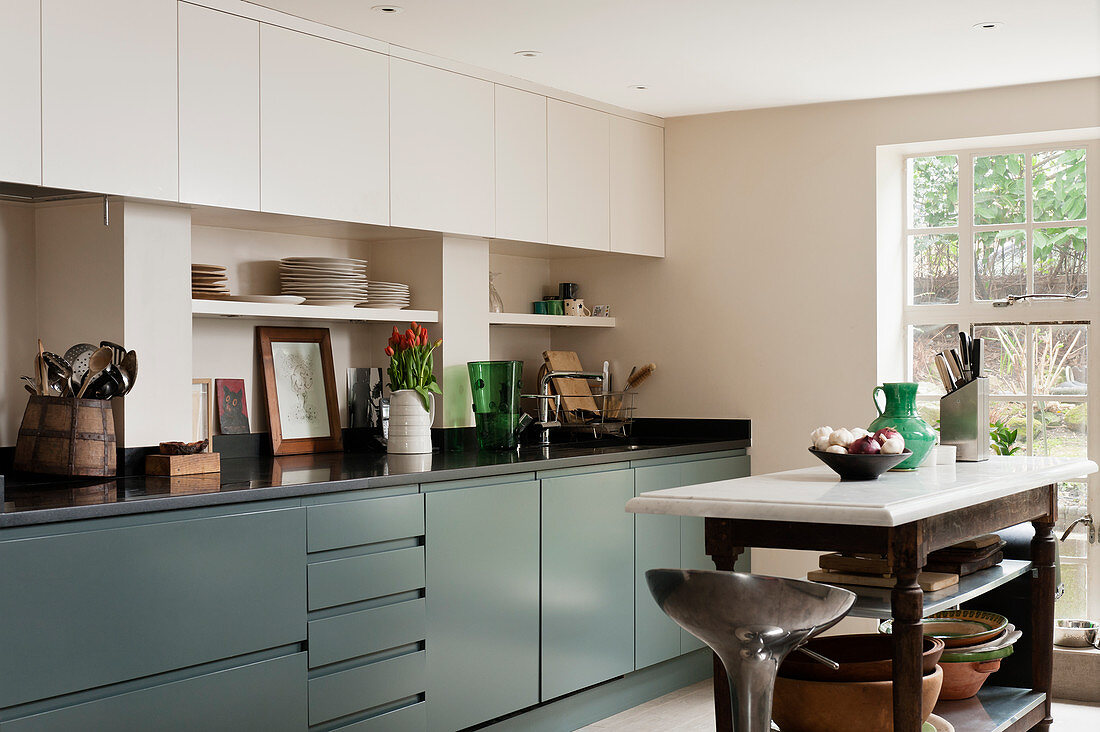 Fitted kitchen with cupboards painted, the butchers island is made from an old French table and customised with aluminium shelves