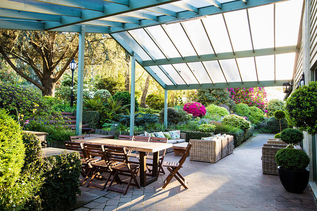 Dining table with chairs and lounge furniture on the covered terrace