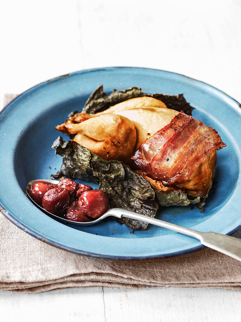 Quail cooked in vine leaves and wrapped in pancetta with grape confit