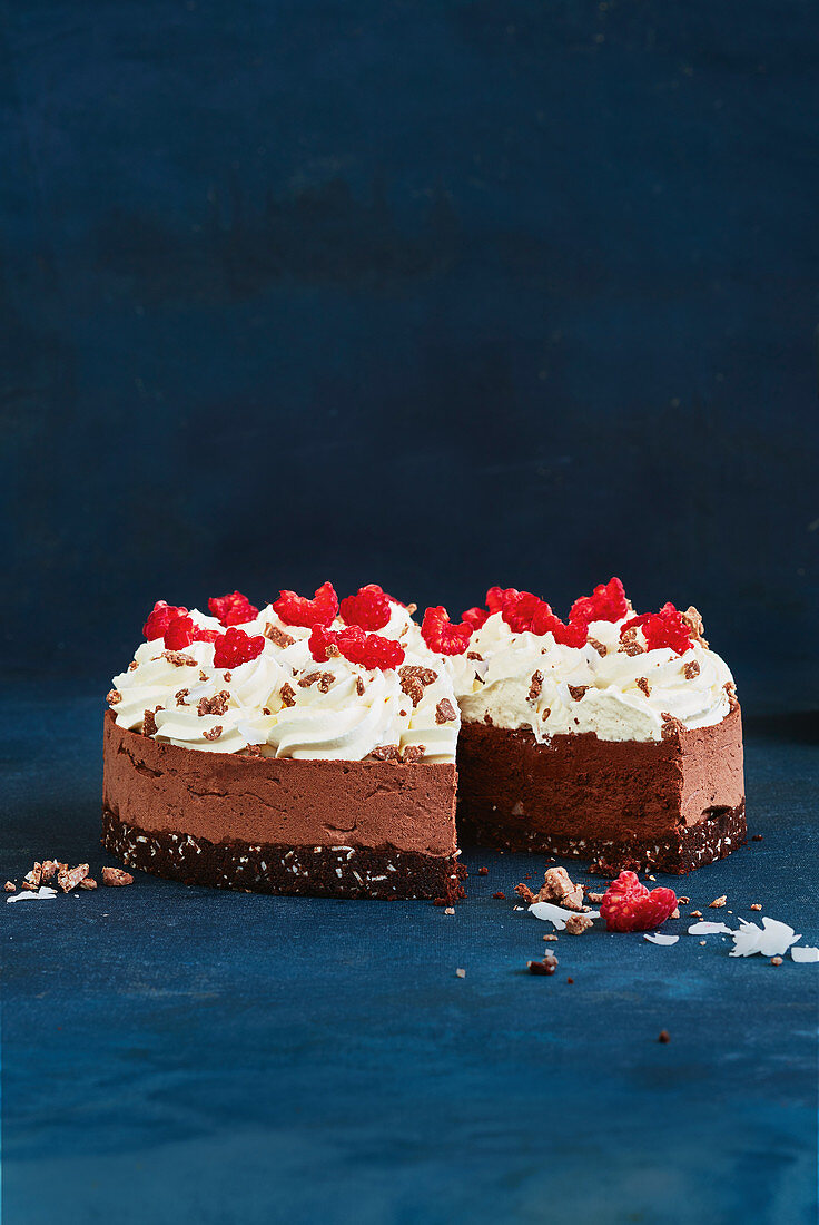 Chocolate mousse cake with coconut, cream and raspberries