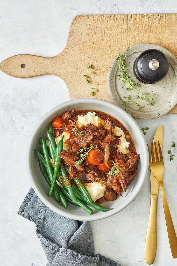 Slow cooker beef brisket bourguignon with mashed potatoes and beans