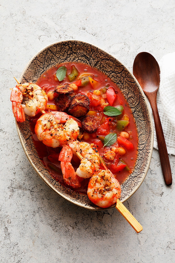 Tomato soup with fried plantain and prawn skewers (Africa)