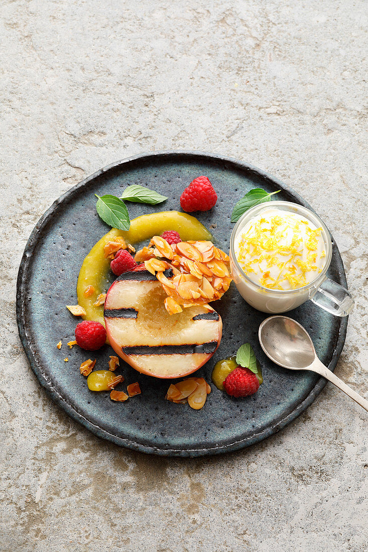 Lemon posset, grilled peaches, mango puree and almond brittle