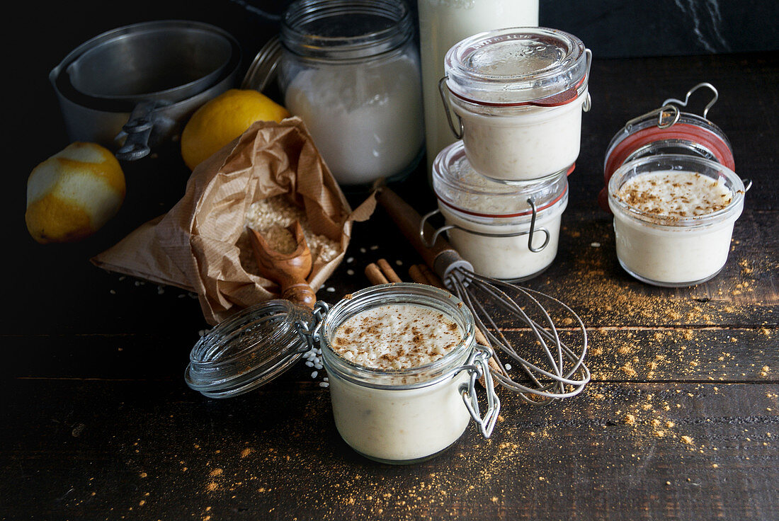 Glass jars with delicious sweet dessert of rice with milk and cinnamon