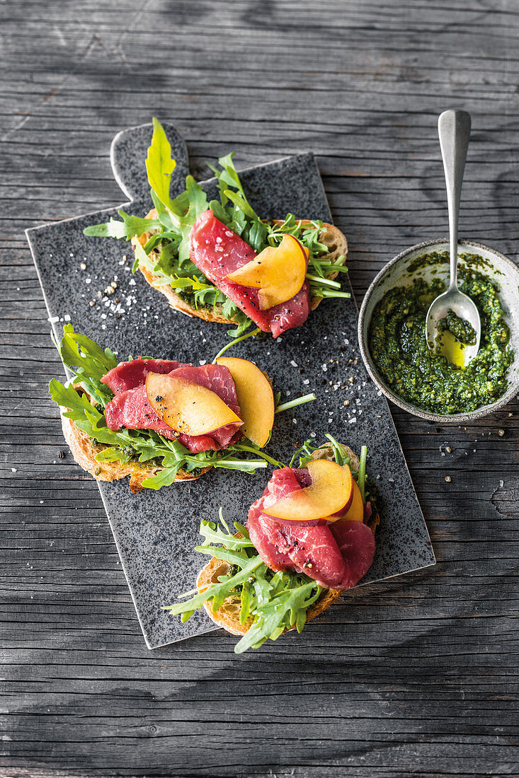 Bruschetta with beef fillet carpaccio and peaches