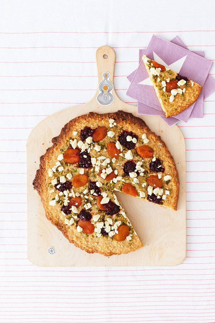 Cookie pizza with soft apricots, pistachios and cranberries