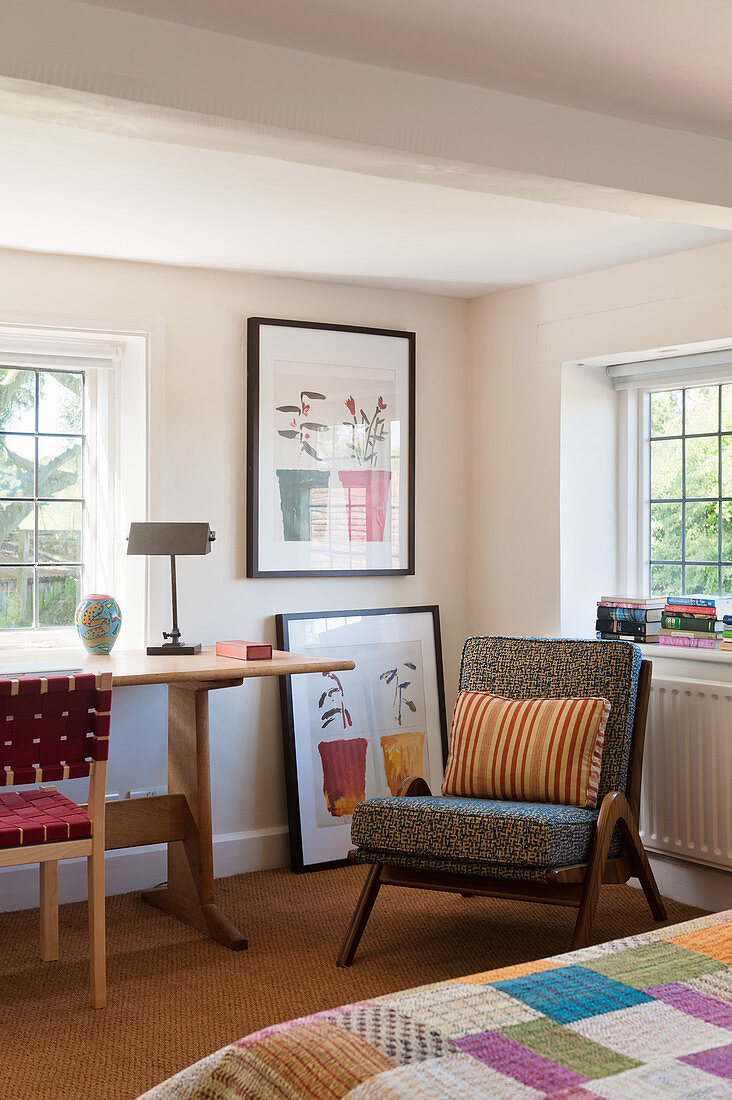 Arts and crafts table in bedroom with 1950s English chair and Indian bed cover