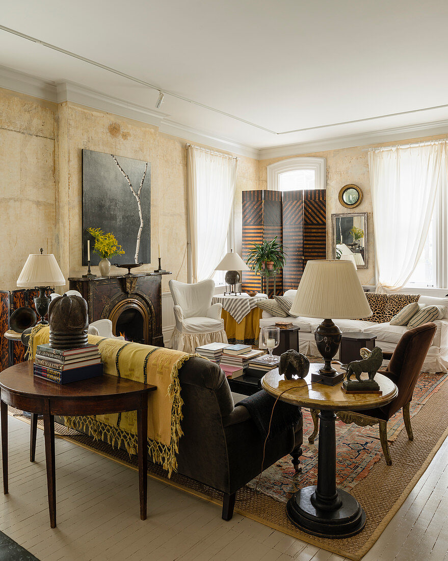 White muslin window drapes and 4-segment screen in eclectically furnished living room