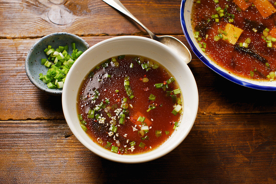 Japanese miso soup with tofu, wakame seaweed, spring onions and pepper flakes