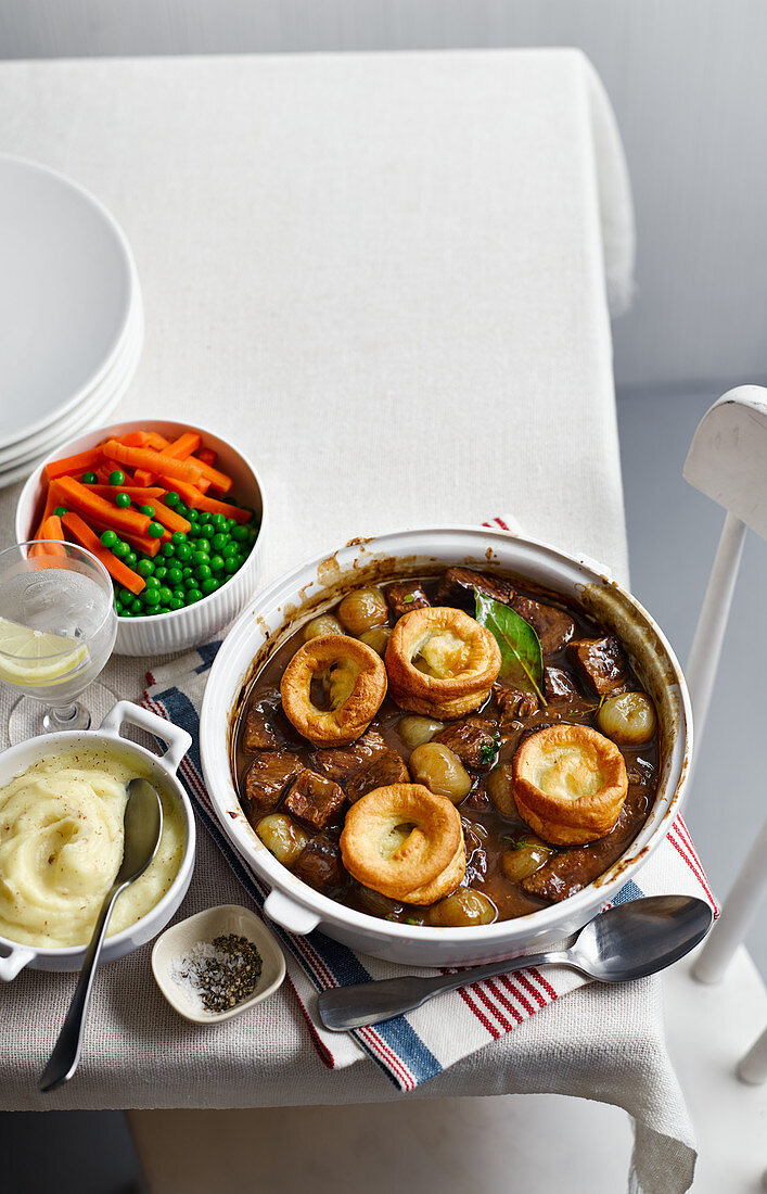 Beef stew with Yorkshire puddings, mashed potatoes and vegetables