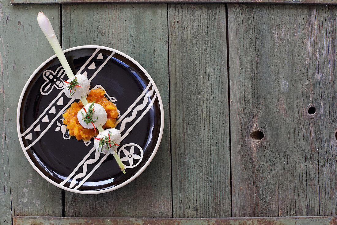 Oriental chicken dumpling skewer with pineapple and mango chutney