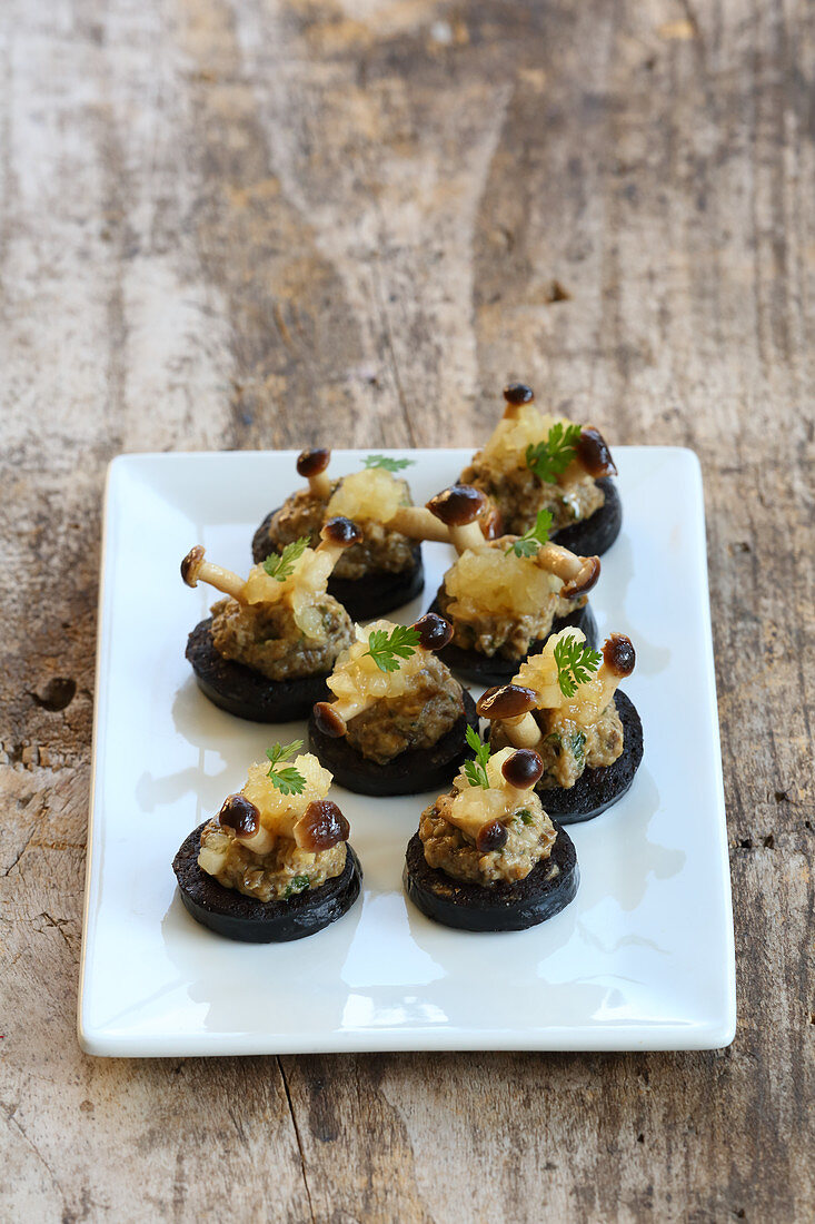 Velvet pioppini canapés with black pudding and pears
