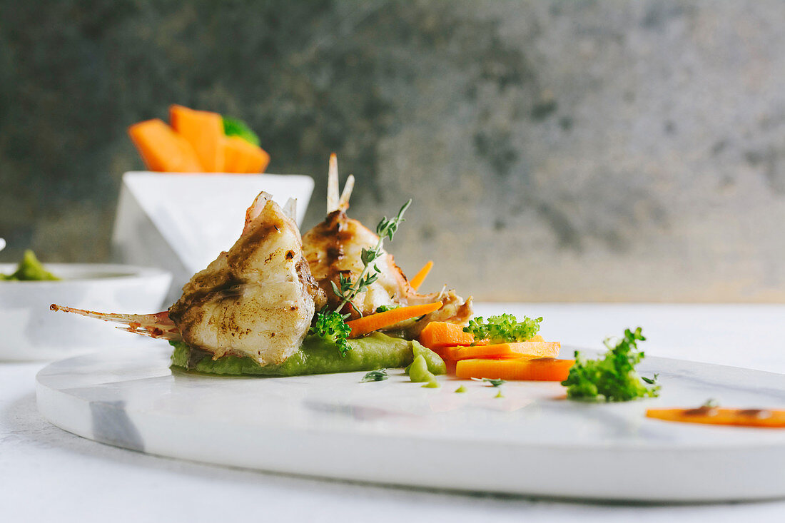 Grilled scorpion fish with mashed peas and carrot sticks